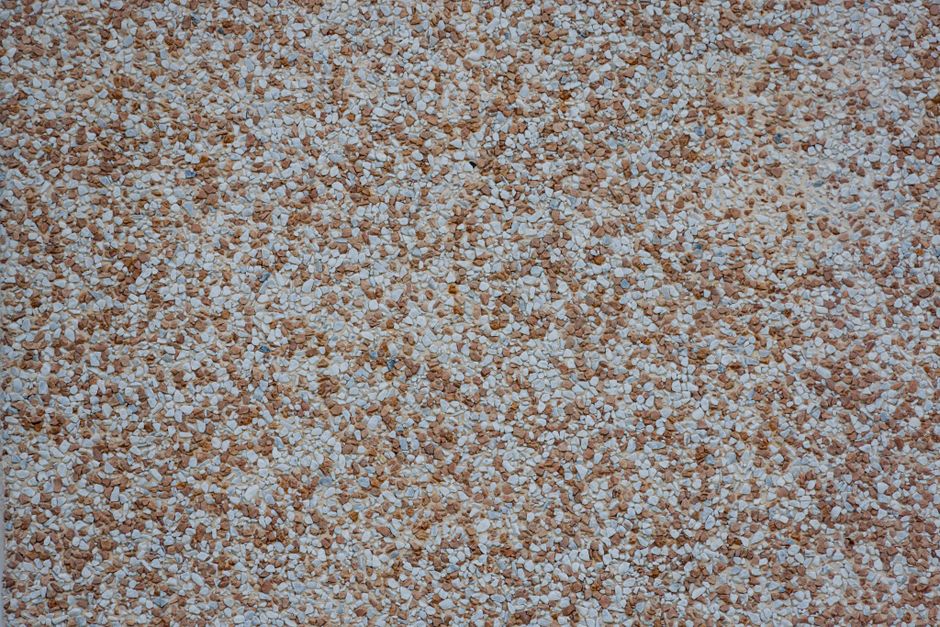 Gros plan sur une moquette de pierre en granulats beiges et blancs